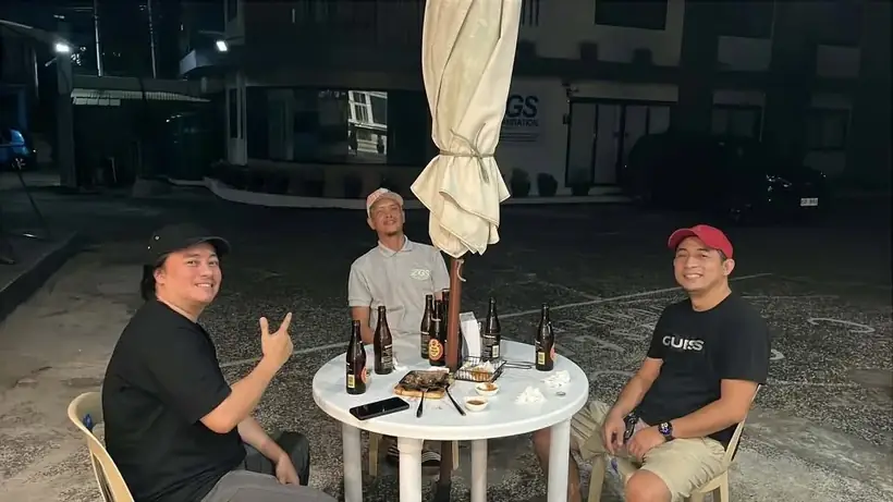 Friends relaxing together outside Harong ni Kadunong